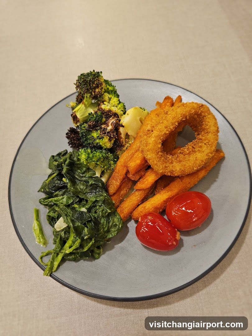 Plate of Food with Broccoli, Sweet Potato Fries, Onion Rings, Spinach and Cherry Tomatoes
