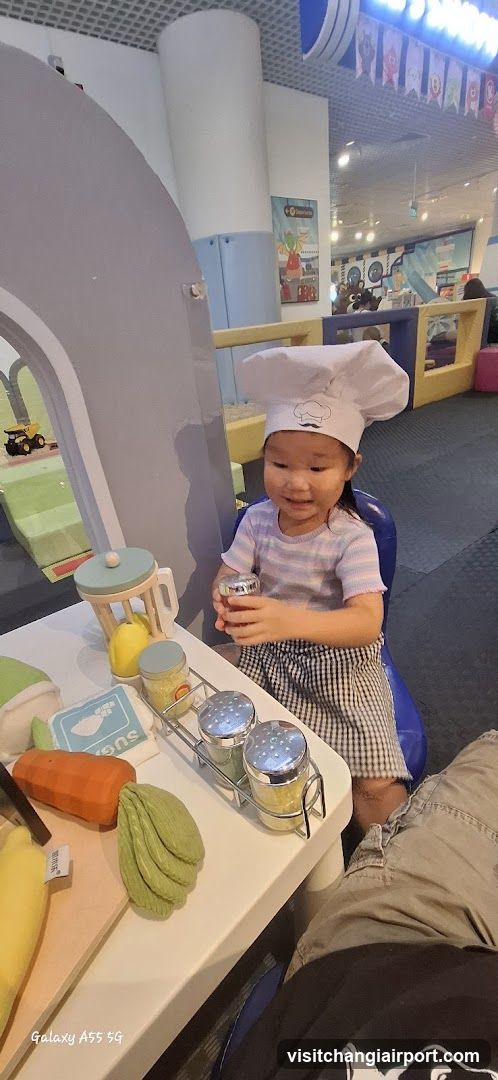 Child in Chef Hat at Play Kitchen