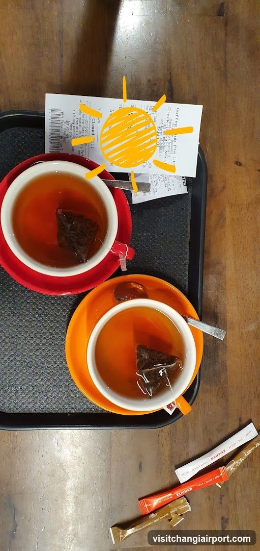 Tea on a tray with receipt and sun drawing