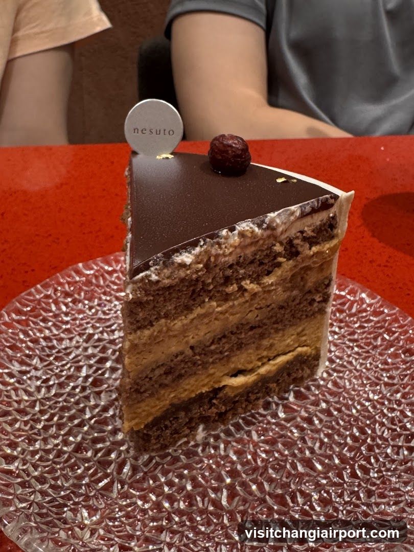 Slice of layered cake on textured glass plate