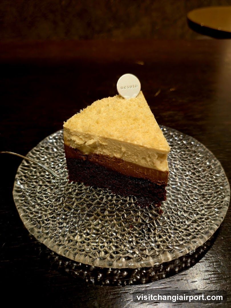 Slice of layered cake on textured glass plate