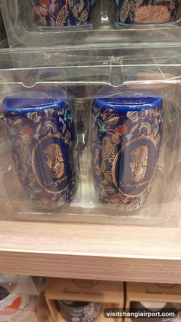 Singapore-themed mugs on display shelf