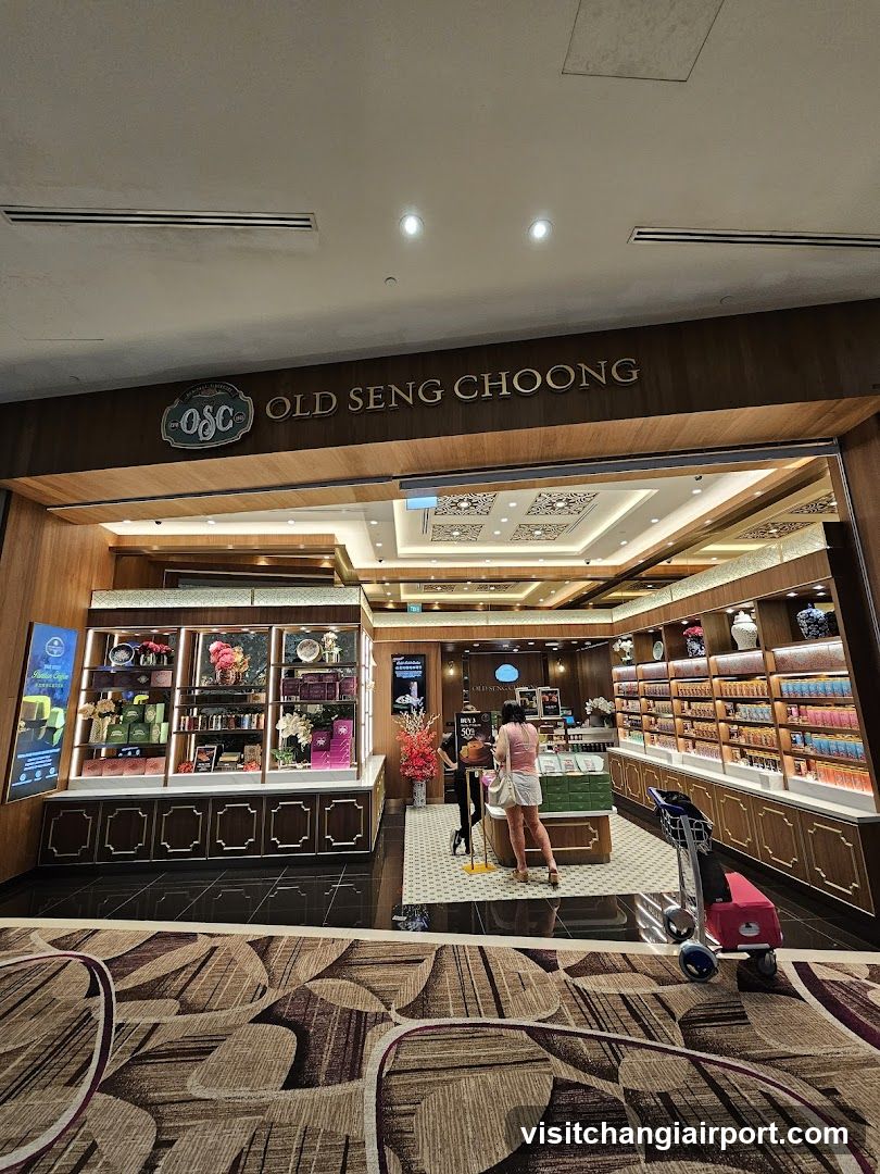 The image shows the entrance of Old Seng Choong, a shop with visible signage above the door. The store interior is partially visible through the open doorway, displaying shelves filled with various products and decorative items. A few customers are browsing inside.