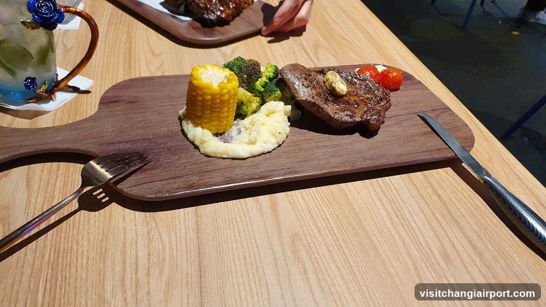 Steak and Corn on Wooden Board