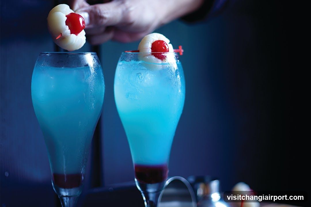 Blue Cocktail with Cherry Garnish
