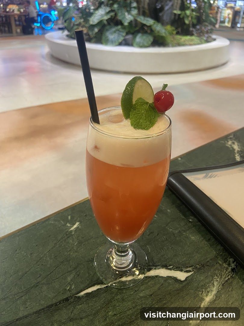 Cocktail with Lime and Cherry Garnish