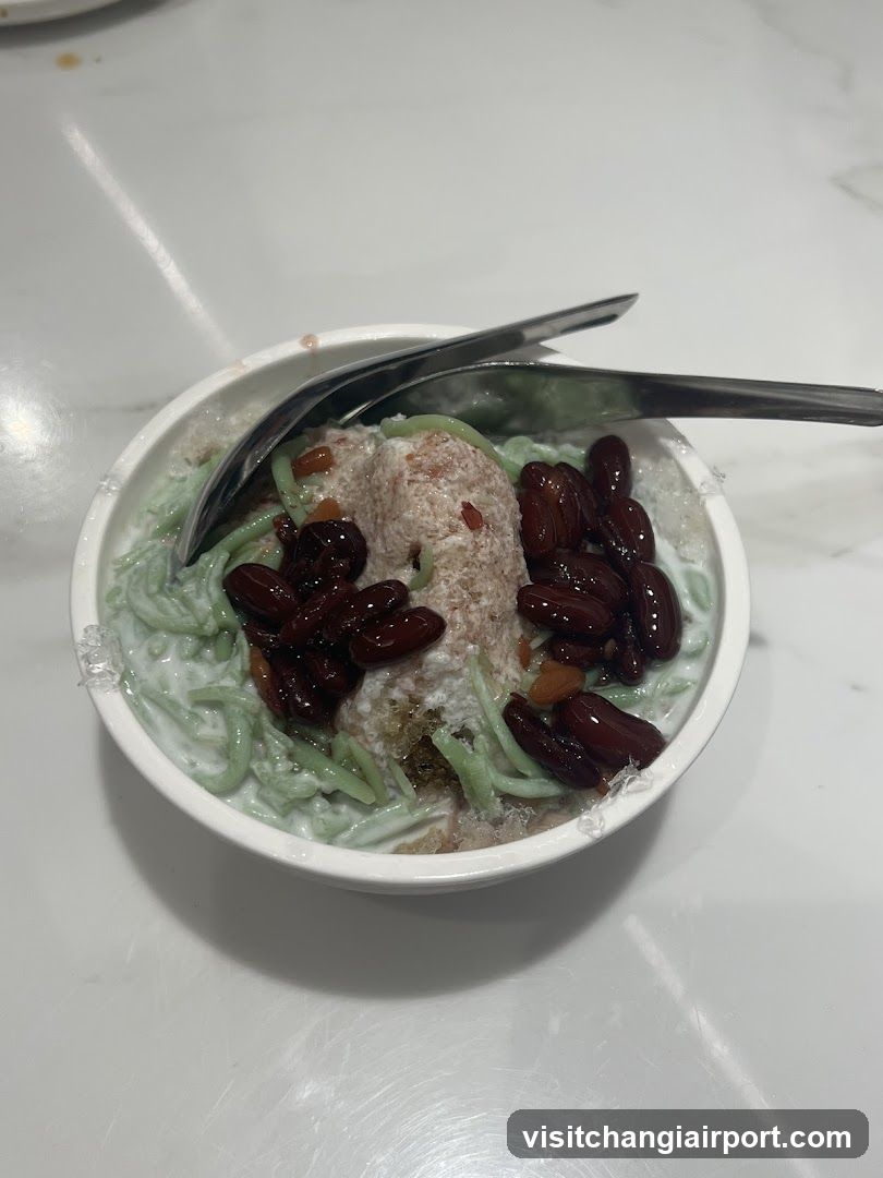 Bowl of Green Noodles with Red Beans and Coconut