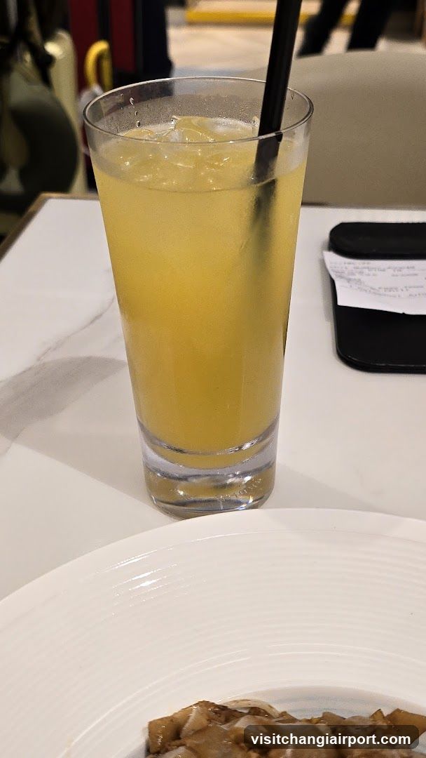 Yellow Drink with Straw and Plate of Food