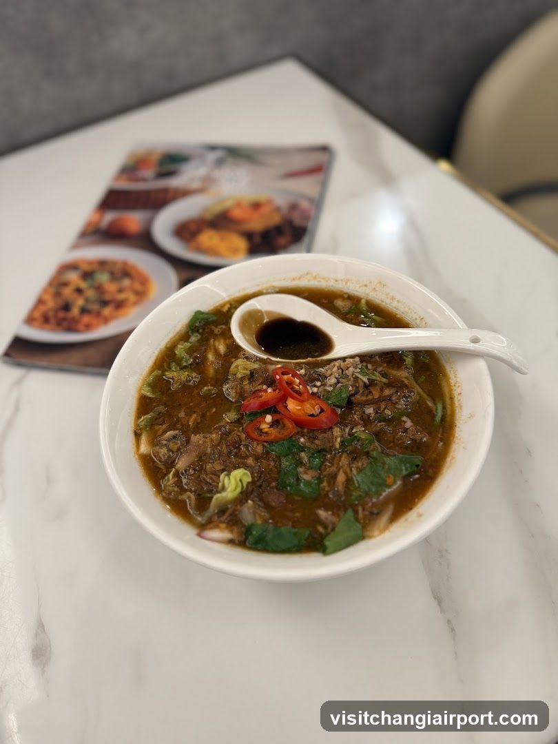 Bowl of Noodle Soup with Chili and Greens