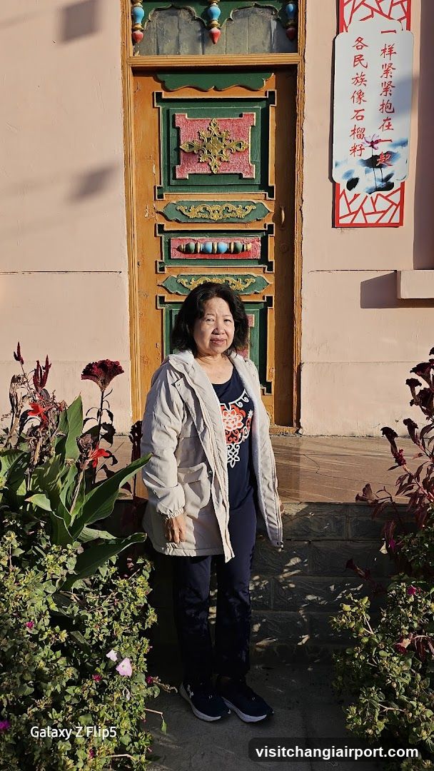 Woman standing in front of a decorated door
