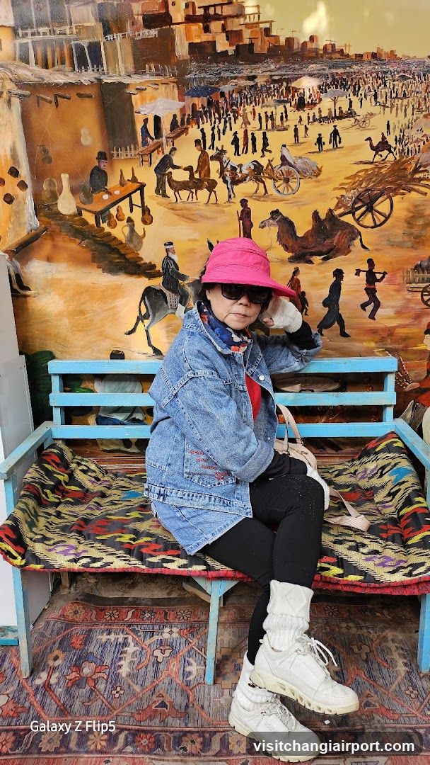 Woman in Pink Hat Sitting on Bench
