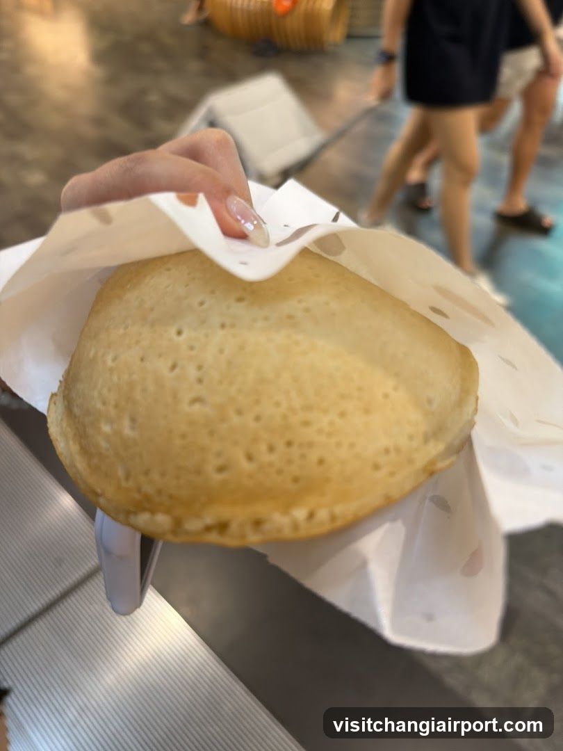 Hand Holding a Golden-Brown Pastry