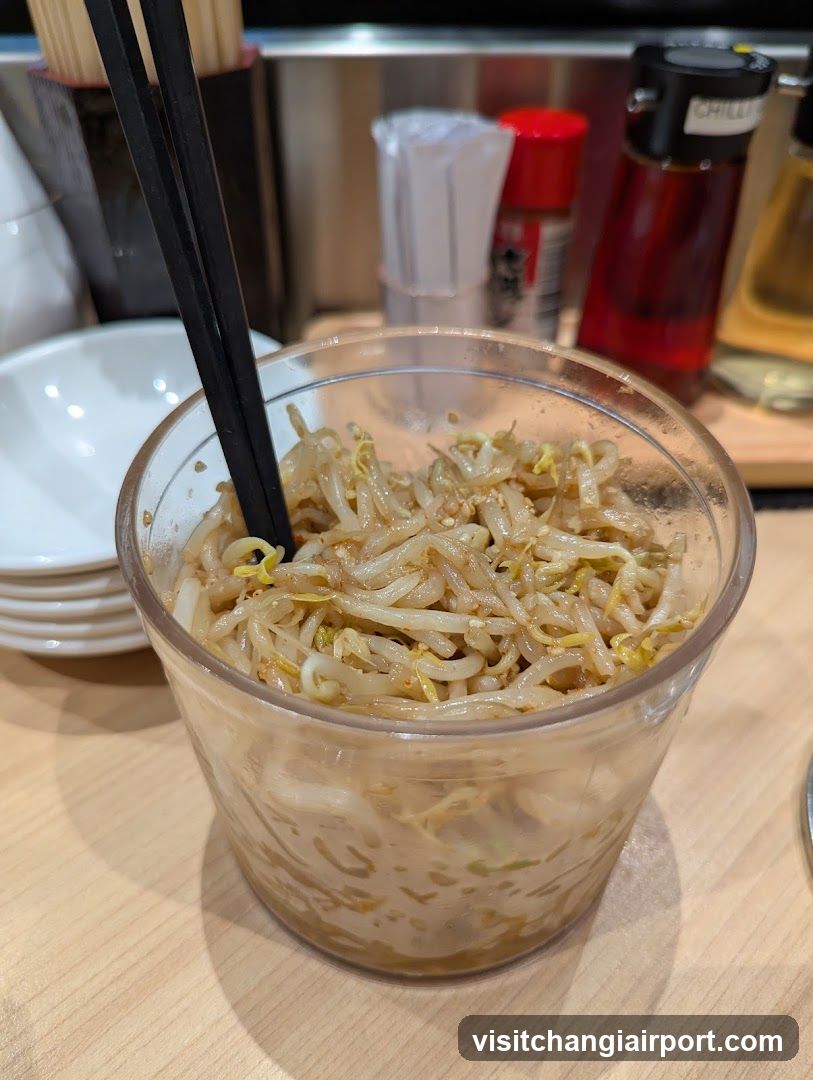 Bowl of bean sprouts with chopsticks