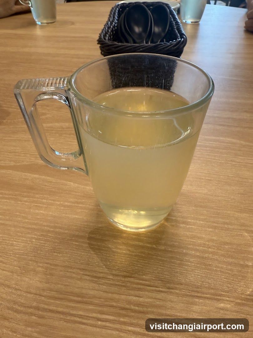 Glass Mug with Light Yellow Liquid on Wooden Table