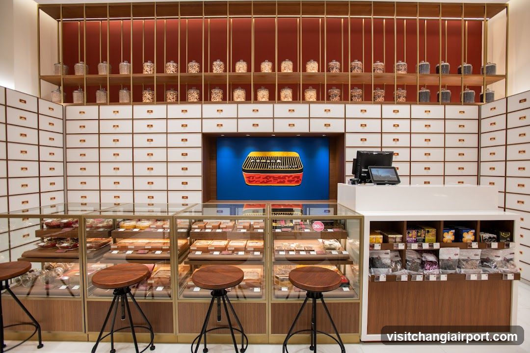Interior of a traditional-style shop with glass display cases and wooden stools.