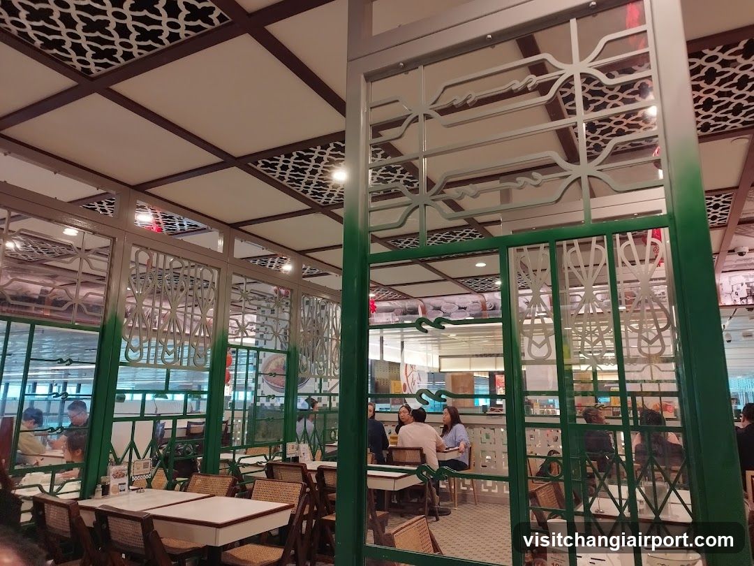 Interior of a restaurant with decorative green partitions and patterned ceiling