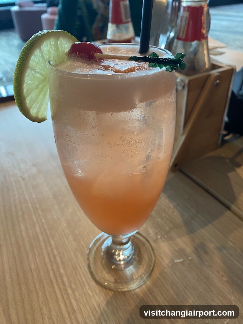 Pink Cocktail with Lime and Cherry Garnish
